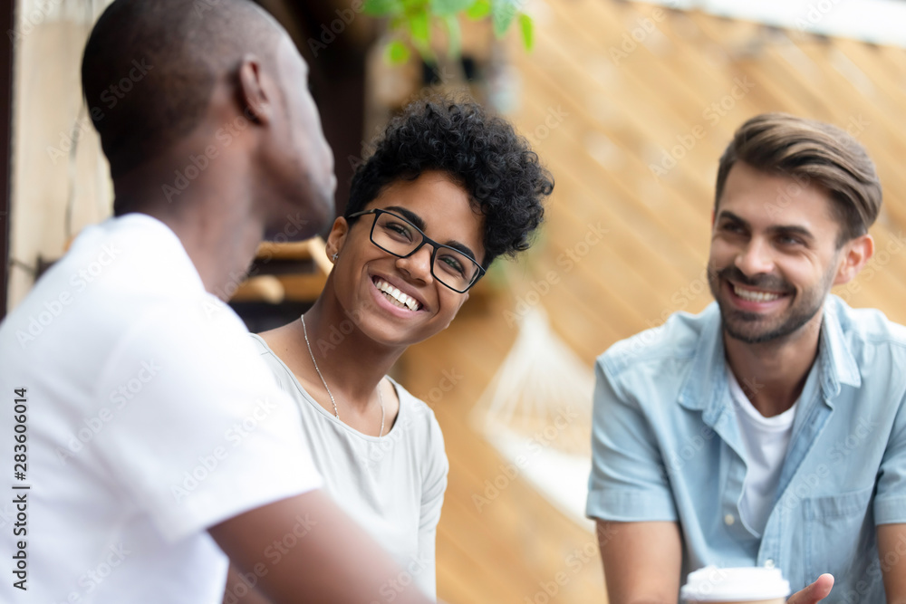 Wall mural Happy diverse young people have fun relaxing together