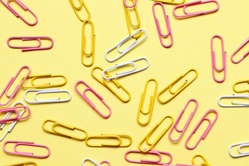 Multi-colored paper clips on a colored background.