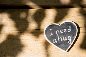 I need a hug hand drawing phrase on a heart, Sharing a Hug concept