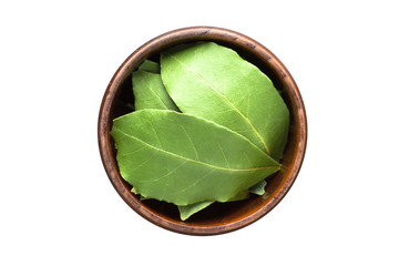 dried bay leaves spice in wooden bowl, isolated on white background. Seasoning top view