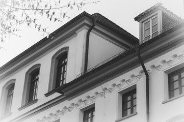 Abstract house architecture detail in monochrome tone. White house facade with windows.