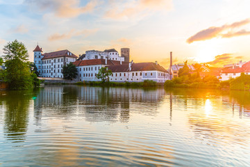 Jindrichuv Hradec Castle at sunset time. Reflected in the Little Vajgar pond, Jindrichuv Hradec, Czech Republic