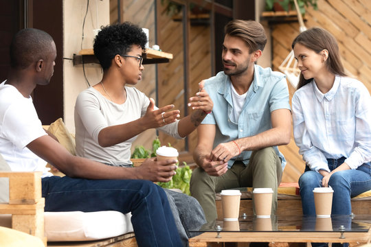 Diverse Young People Relax In Cafe Communicating