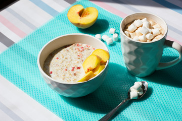Cereal porridge with fruit and milk.