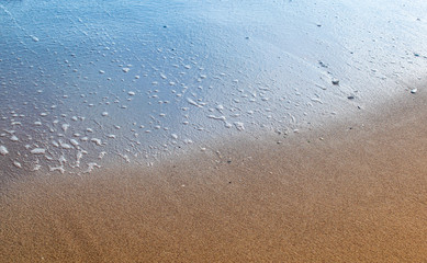 Fototapeta na wymiar Half-wet beach sand background