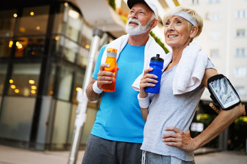 Senior couple staying hydrated after running jogging