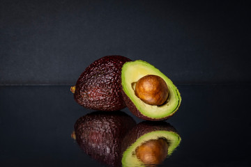 sliced avocado on a mirrored background