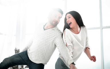 Fototapeta premium happy couple dancing in new house