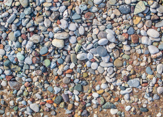 Small pebbles on the beach. Stone background image.