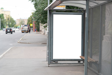 billboard at the bus stop outdoor ad.bus shelter with white field mockup advertisement in the...