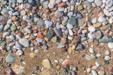 Beach sand and pebbles. Stone background image.