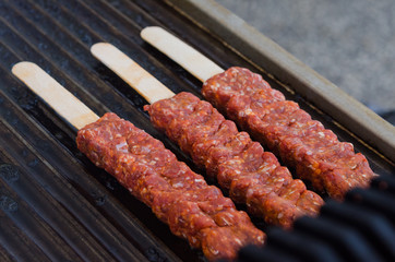 Cooking adana kebabs on a grill in restaurant 