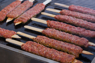Cooking adana kebabs on a grill in restaurant 