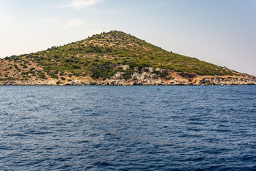 Fototapeta na wymiar Boat trip along the shore of the island of Symi
