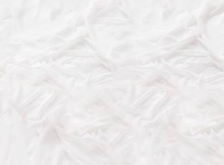 Fototapeta na wymiar White silk fabric. Graceful background with pastel colored folded textile. Cozy stilllife backdrop.