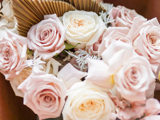 Wedding bouquet. Bride's traditional symbolic accessory. Floral composition with pastel colored roses.
