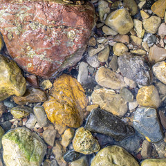 Stones in the water, close-up. Stone background.