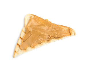 Slice of bread with peanut butter on white background, top view