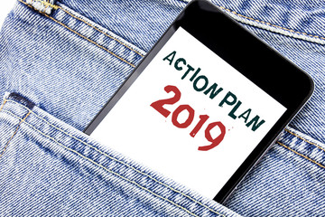 Handwriting Announcement text showing Action Plan 2019. Business concept for Success Strategy Written phone mobile phone, cellphone placed in man front jeans pocket.