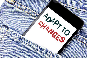 Handwriting Announcement text showing Adapt To Changes. Business concept for Adaptation New Future Written phone mobile phone, cellphone placed in man front jeans pocket.