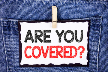 Text sign showing Are You Covered Question. Conceptual photo Health insurance coverage disaster recovery written White Sticky Note Paper hanging with Clip the Jeans background.