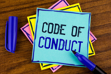 Handwriting text writing Code Of Conduct. Concept meaning Follow principles and standards for business integrity written Sticky note paper wooden background Marker next to it.