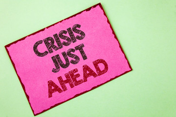Word writing text Crisis Just Ahead. Business concept for Foresee failure take right action before it is late written Pink sticky note paper plain background.