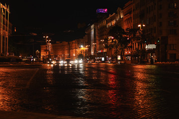 KYIV, UKRAINE - MAY 21, 2019: Night cityscape with illuminated buildings and street traffic