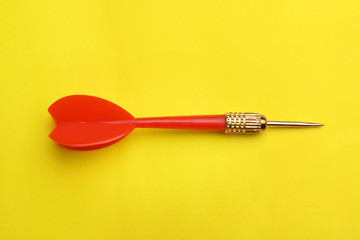 Red dart arrow on yellow background, top view