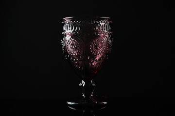 Elegant empty colorful glass on black background