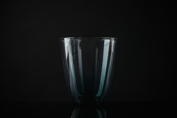 Elegant empty colorful glass on black background