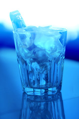 Macro photo of blue coarse ice in a transparent glass