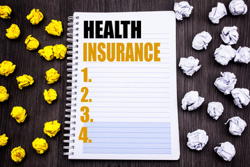 Conceptual hand writing text caption showing Health Insurance. Business concept for Medical Healthcare Written notepad note notebook book wooden background with sticky folded yellow and white