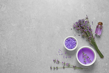 Obraz na płótnie Canvas Flat lay composition with natural cosmetic products and lavender flowers on grey stone background. Space for text