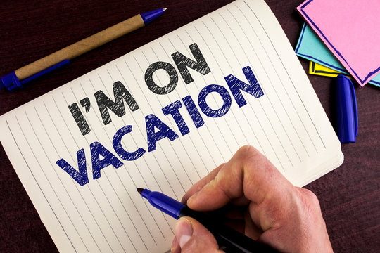 Conceptual hand writing showing I Am im On Vacation. Business photo showcasing Break from stressful work pressure travel worldwide written by Man Notebook Book wooden background Pen.