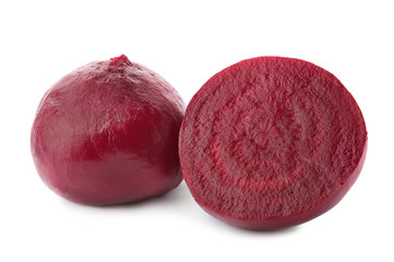 Whole and cut boiled red beets on white background
