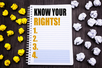 Conceptual hand writing text caption showing Know Your Rights. Business concept for Justice Education Written notepad note notebook book wooden background with sticky folded yellow and white