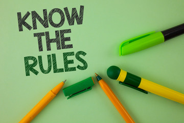 Handwriting text writing Know The Rules. Concept meaning Understand terms and conditions get legal advice from lawyers written Plain Green background Pens next to it.