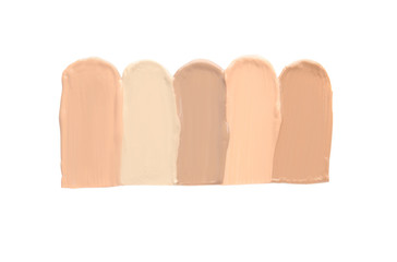 Samples of different foundation shades on white background, top view
