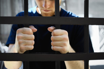 Man detained in jail outdoors, closeup. Criminal law - obrazy, fototapety, plakaty