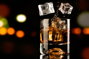 glass of whiskey and ice cube