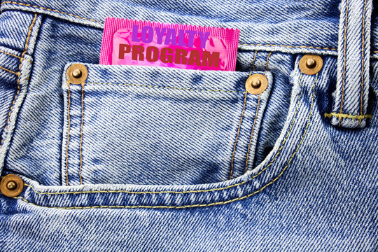 Handwritten text showing Loyalty Program. Business concept writing for Marketing Concept Written on condom pack in small pocket in the pants jeans.