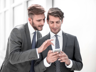 young employees discussing media files on a smartphone