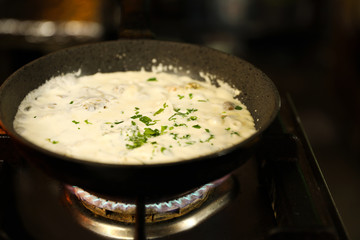 Cooking delicious noodles with melted cheese on frying pan