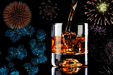 celebration,  glass of whiskey and ice cube 