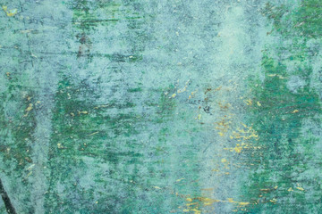 Green grunge painted wall surface worn weathered dirty old rough vintage background surface texture