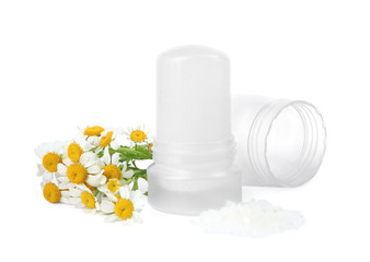 Natural crystal alum deodorant with chamomile flowers and bath salt on white background