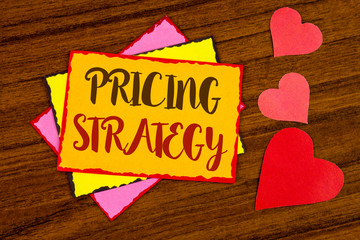 Text sign showing Pricing Strategy. Conceptual photo Marketing sales strategies profit promotion campaign written Sticky note paper wooden background Hearts next to it.