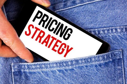 Text sign showing Pricing Strategy. Conceptual photo Marketing sales strategies profit promotion campaign written Mobile phone holding by man the Blue Jeans background.