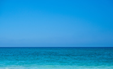 Fototapeta na wymiar Turquoise color sea and blue sky. Seascape background image.